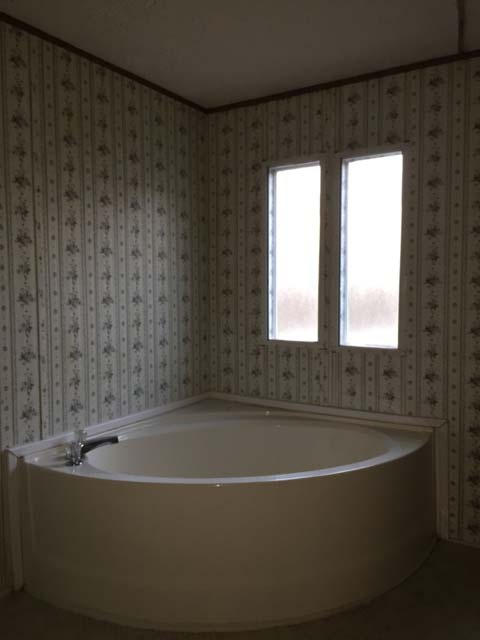 1948 Parker Road Cantonment, FL 32533 - Photo 22 of 28 a bathroom with a bathtub and a shower
