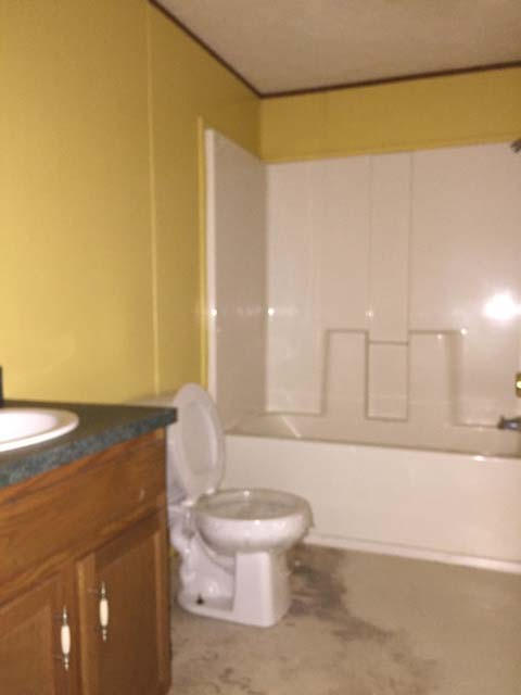 1948 Parker Road Cantonment, FL 32533 - Photo 28 of 28 a bathroom with a granite countertop sink and a toilet