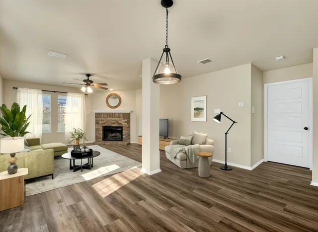 a living room with furniture and a fireplace