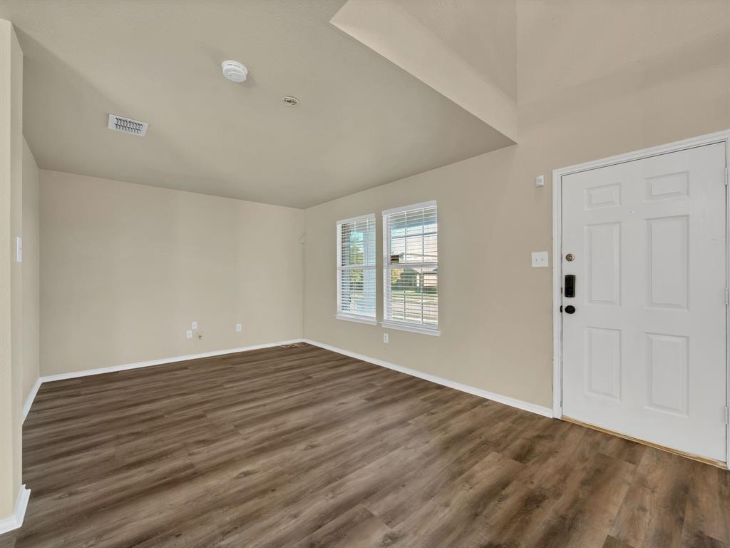 2917 Mayfair Lane Lancaster, TX 75134 - Photo 13 of 40 Foyer entrance with dark wood-style flooring and baseboards