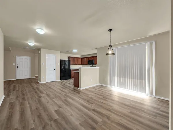 a view of a kitchen with a sink and an empty room