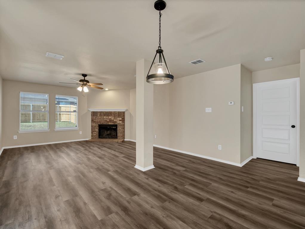 2917 Mayfair Lane Lancaster, TX 75134 - Photo 17 of 40 Unfurnished living room featuring a fireplace, dark wood-type flooring, and ceiling fan