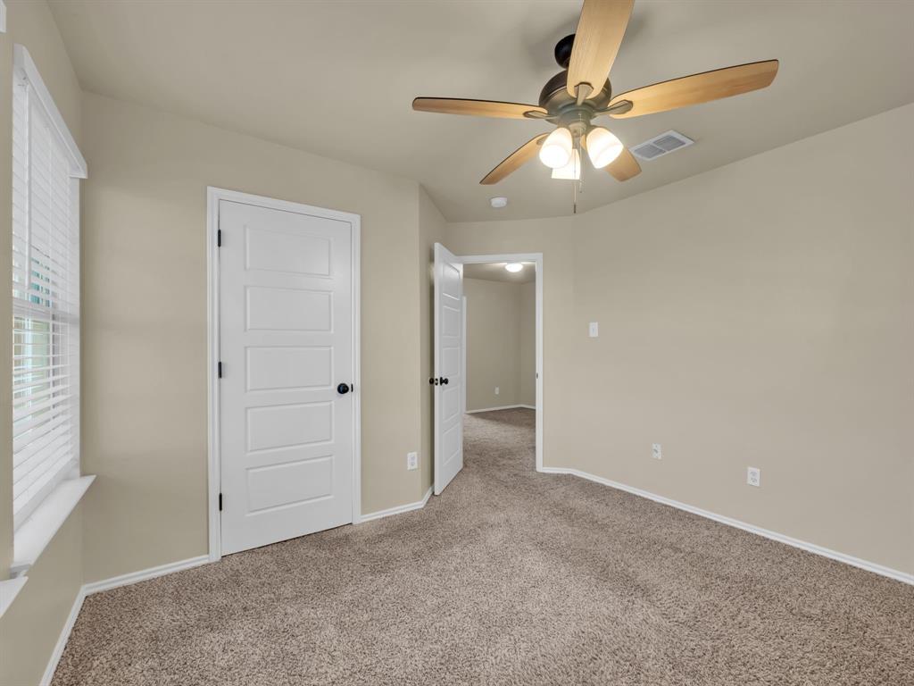 2917 Mayfair Lane Lancaster, TX 75134 - Photo 20 of 40 Unfurnished bedroom featuring carpet flooring and a ceiling fan