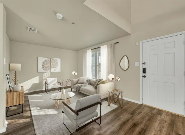 a living room with furniture a table and a chandelier