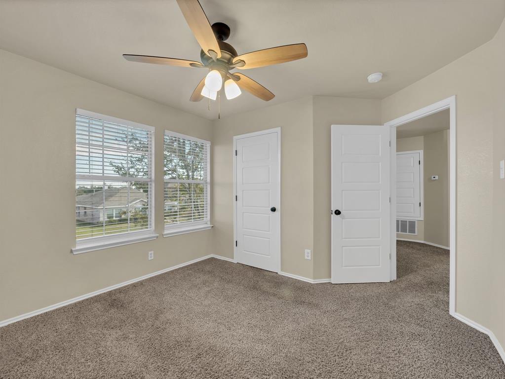 2917 Mayfair Lane Lancaster, TX 75134 - Photo 21 of 40 Unfurnished bedroom featuring carpet, ceiling fan, and a closet