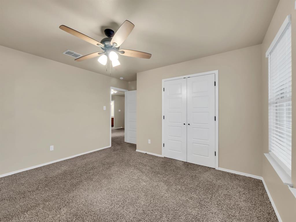 2917 Mayfair Lane Lancaster, TX 75134 - Photo 22 of 40 Unfurnished bedroom featuring carpet, ceiling fan, and a closet