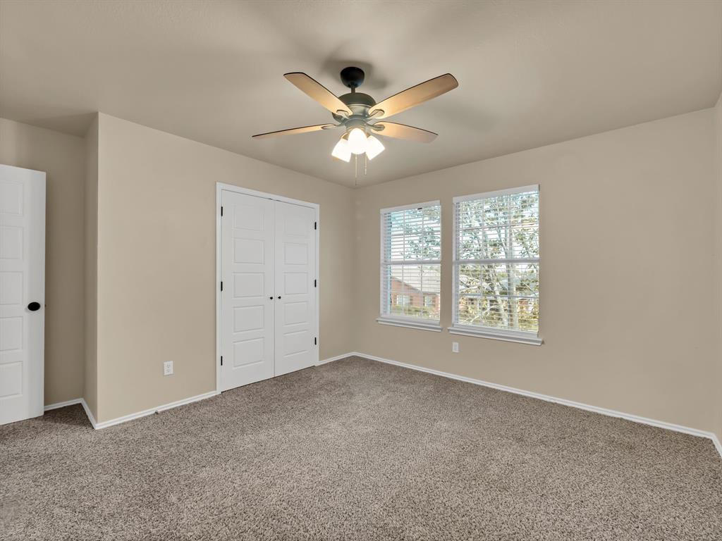 2917 Mayfair Lane Lancaster, TX 75134 - Photo 23 of 40 Unfurnished bedroom with carpet flooring, a closet, and ceiling fan