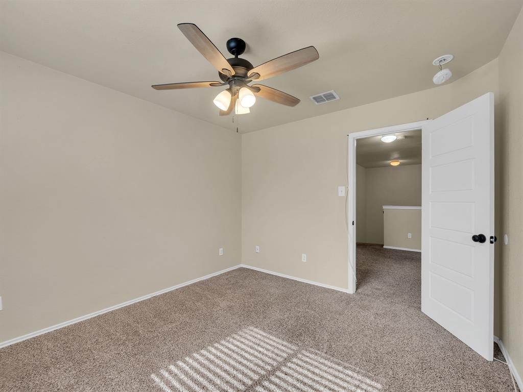 2917 Mayfair Lane Lancaster, TX 75134 - Photo 25 of 40 Spare room with carpet floors and ceiling fan