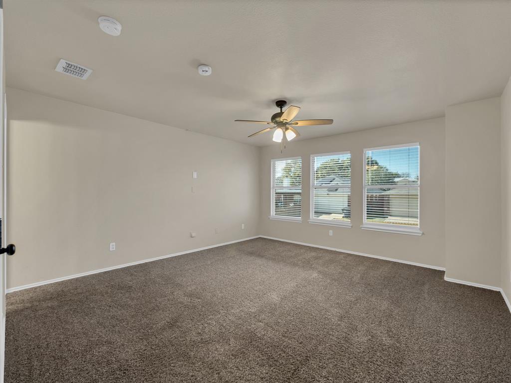 2917 Mayfair Lane Lancaster, TX 75134 - Photo 29 of 40 Spare room featuring dark carpet and ceiling fan