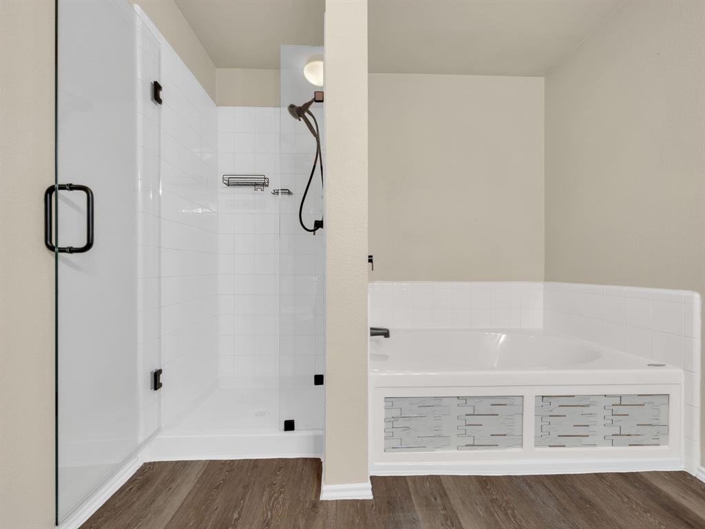 2917 Mayfair Lane Lancaster, TX 75134 - Photo 30 of 40 Full bathroom with a stall shower, dark wood finished floors, and a garden tub