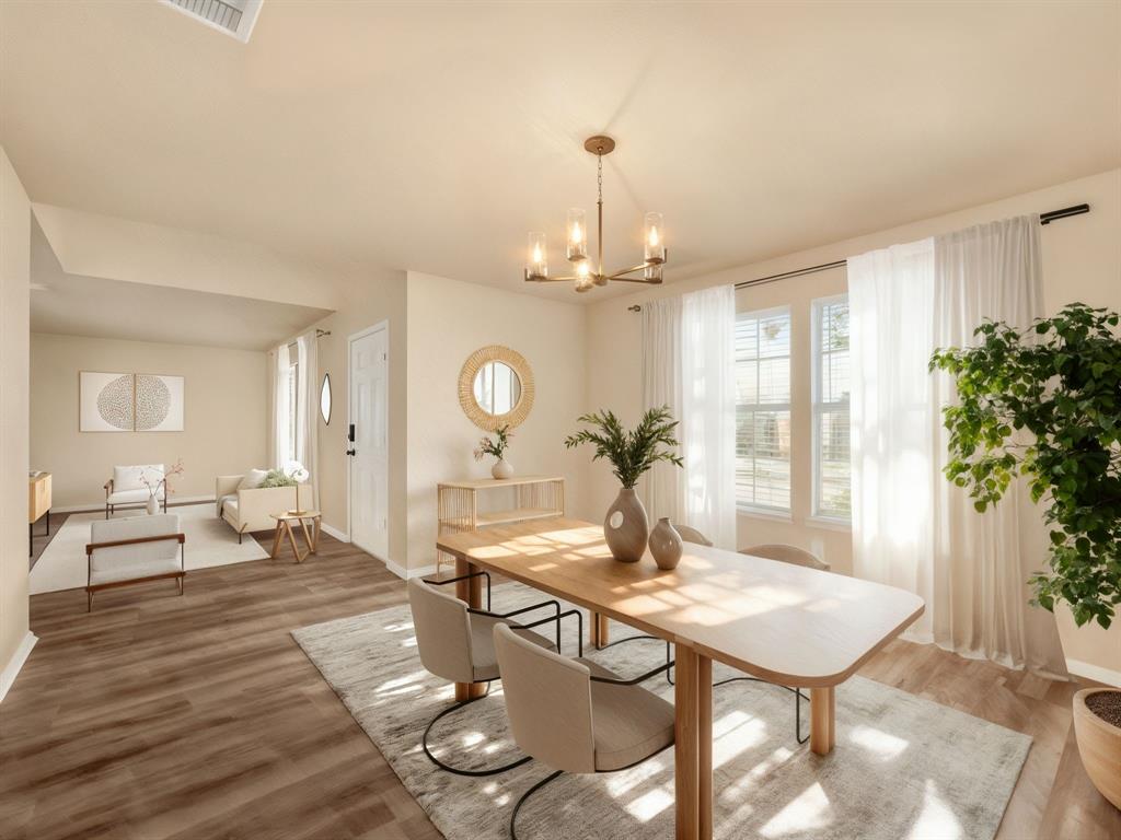 2917 Mayfair Lane Lancaster, TX 75134 - Photo 3 of 40 Staged Dining space featuring wood finished floors and a chandelier