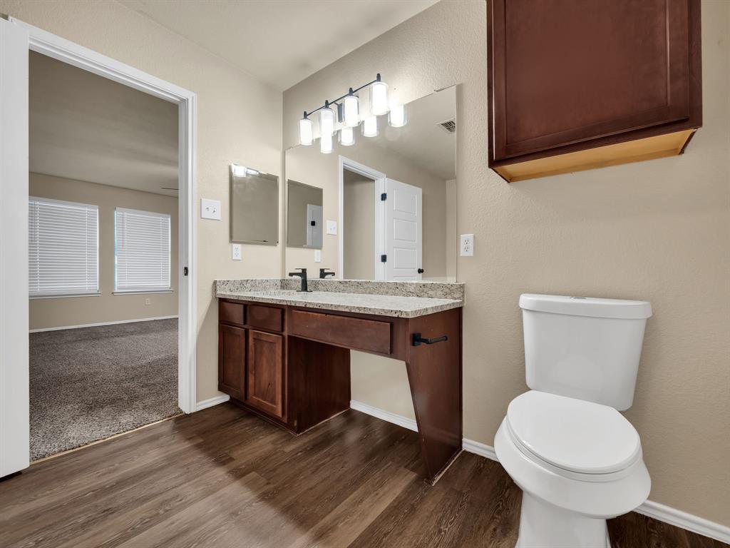 2917 Mayfair Lane Lancaster, TX 75134 - Photo 31 of 40 Bathroom with vanity and dark wood-style floors