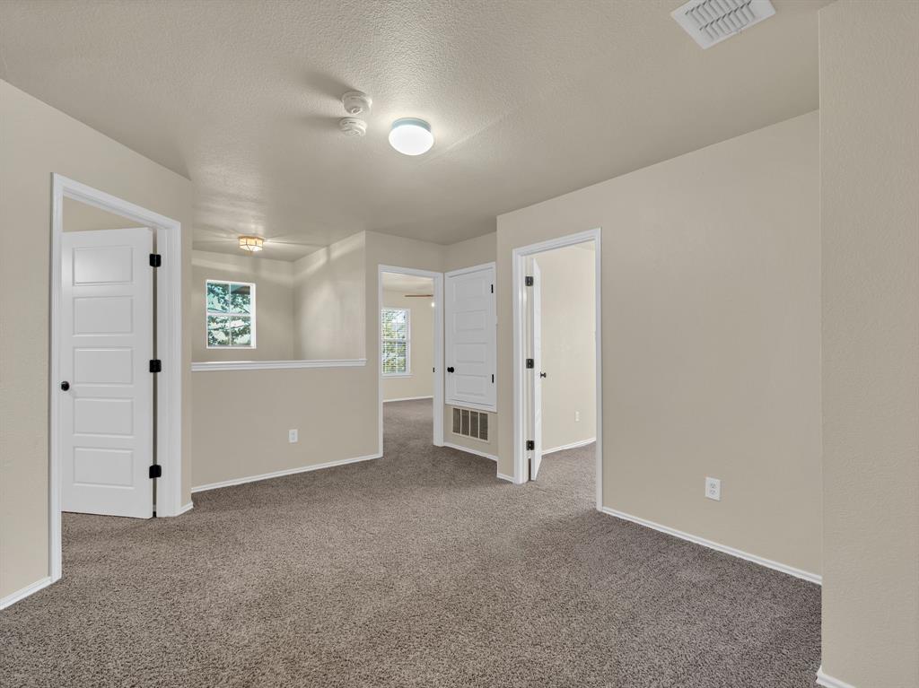 2917 Mayfair Lane Lancaster, TX 75134 - Photo 33 of 40 Carpeted spare room with a textured ceiling and baseboards