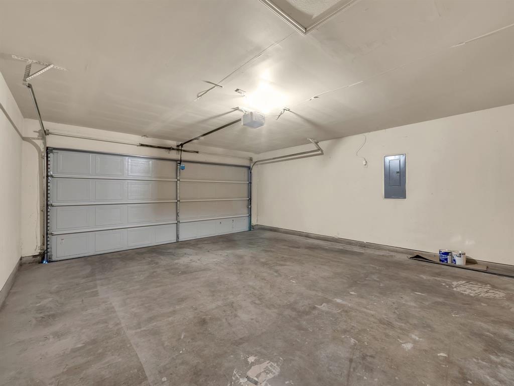 2917 Mayfair Lane Lancaster, TX 75134 - Photo 35 of 40 Garage with electric panel and a garage door opener