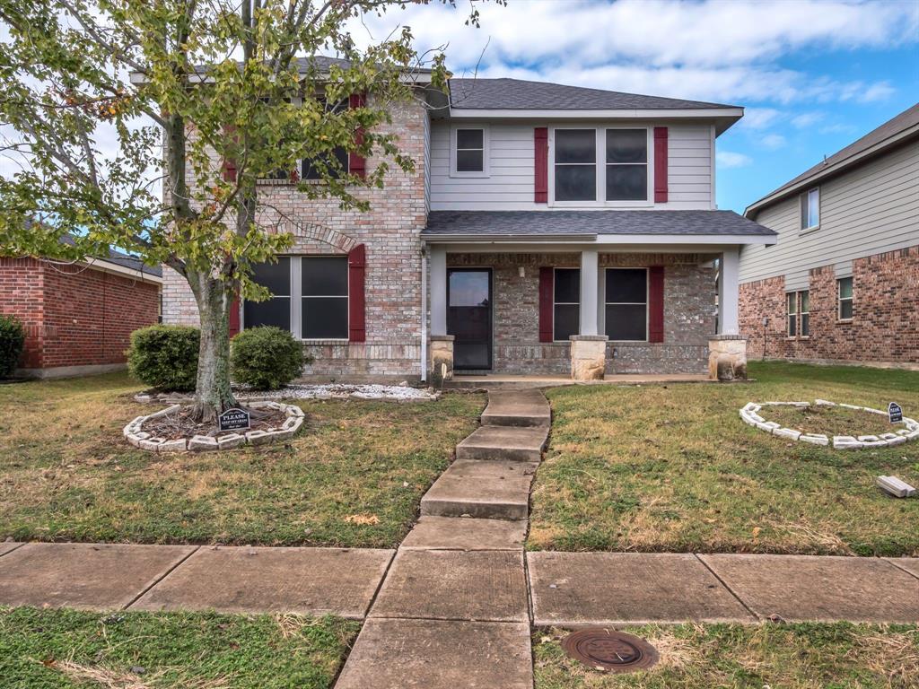 2917 Mayfair Lane Lancaster, TX 75134 - Photo 6 of 40 Traditional-style home featuring covered porch, roof with shingles, a front yard, and brick siding