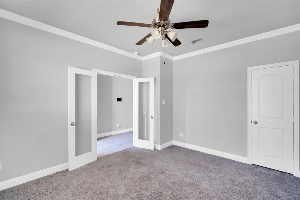 117 Melody Way Red Oak, TX 75154 - Photo 14 of 40 Unfurnished bedroom with crown molding, french doors, light colored carpet, and ceiling fan