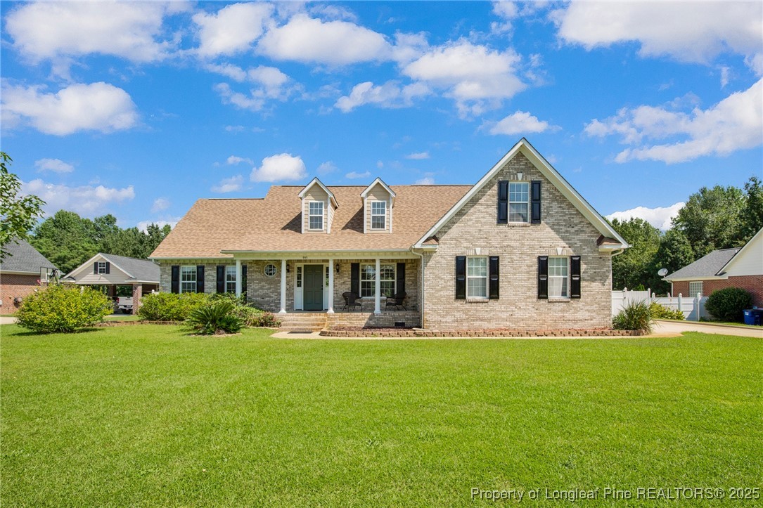 a front view of house with yard and green space