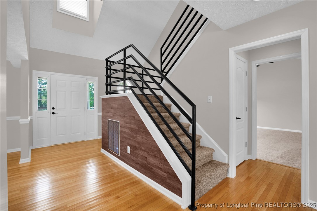 995 Adcox Road Raeford, NC 28376 - Photo 11 of 50 a view of a livingroom with wooden floor and stairs