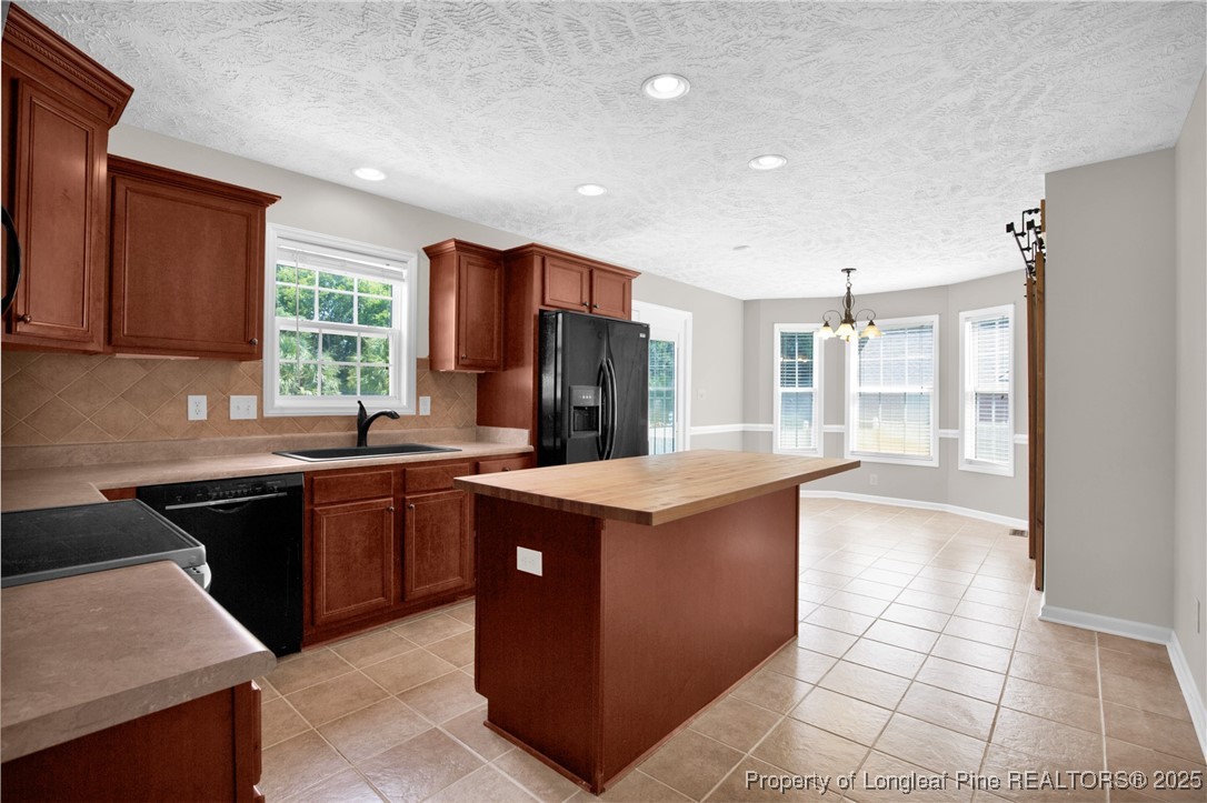 995 Adcox Road Raeford, NC 28376 - Photo 18 of 50 a kitchen with stainless steel appliances granite countertop a stove and a refrigerator