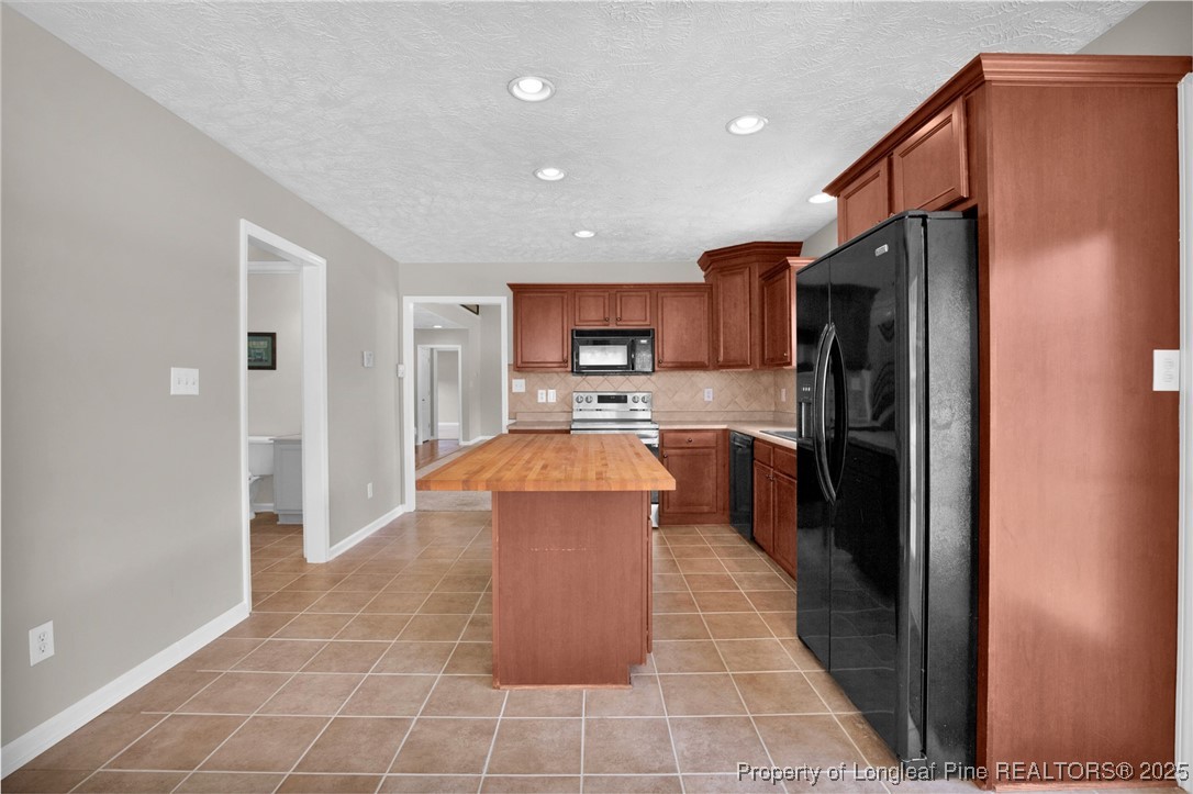 995 Adcox Road Raeford, NC 28376 - Photo 20 of 50 a kitchen with stainless steel appliances granite countertop a refrigerator a sink a stove top oven and a oven