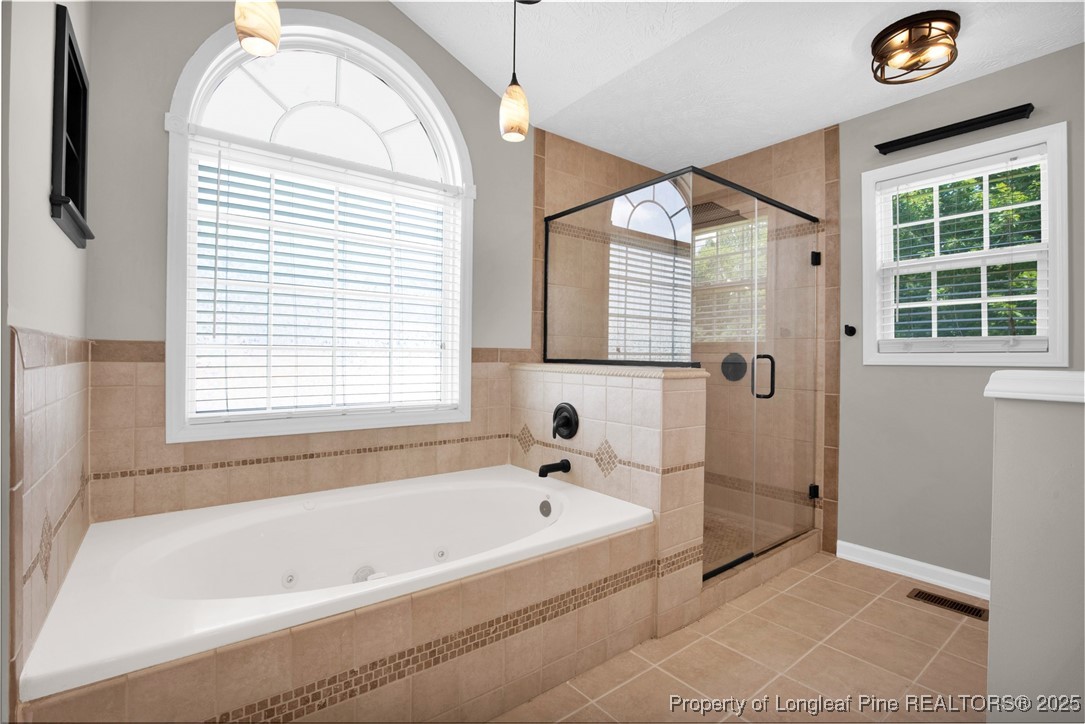 995 Adcox Road Raeford, NC 28376 - Photo 29 of 50 a bathroom with a bathtub and a shower