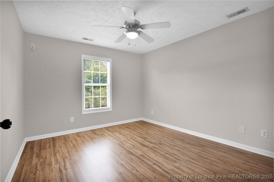 995 Adcox Road Raeford, NC 28376 - Photo 38 of 50 wooden floor in an empty room with a window