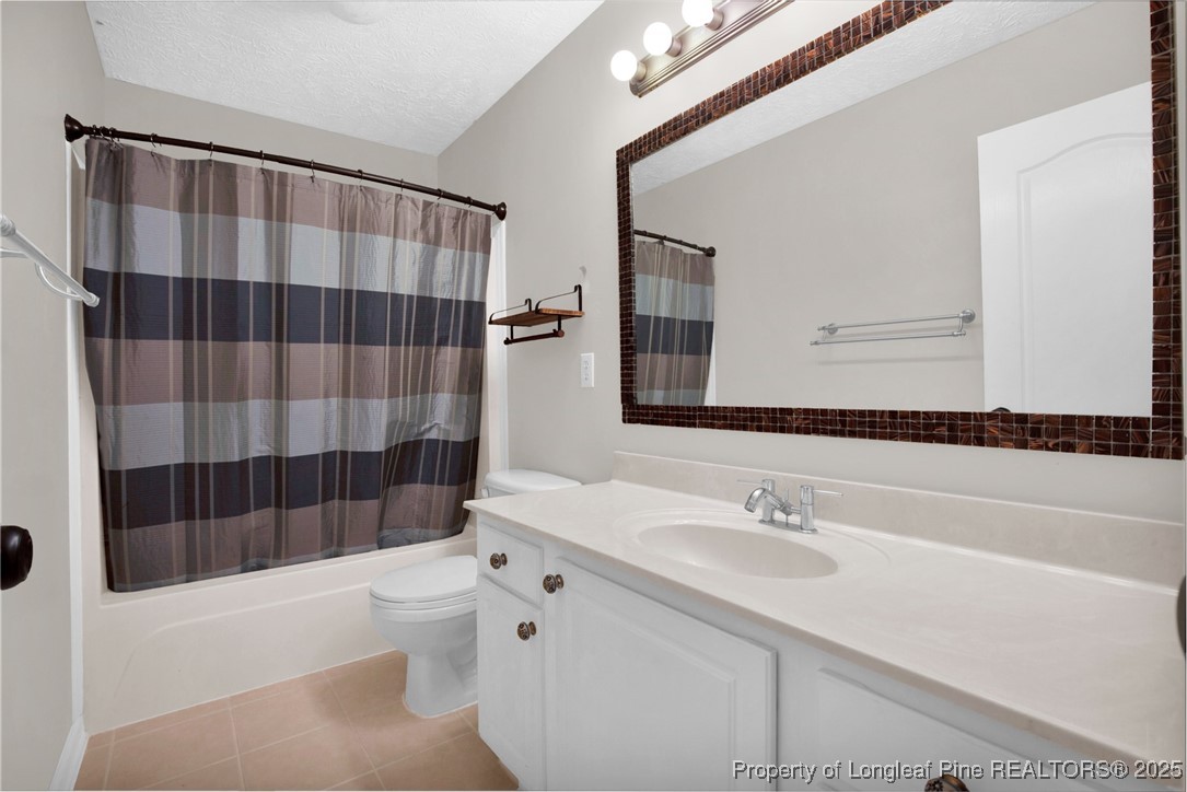 995 Adcox Road Raeford, NC 28376 - Photo 40 of 50 a bathroom with a sink a toilet a shower and a mirror