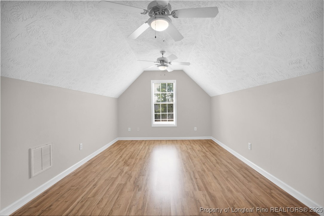 995 Adcox Road Raeford, NC 28376 - Photo 42 of 50 an empty room with wooden floor ceiling fan and window