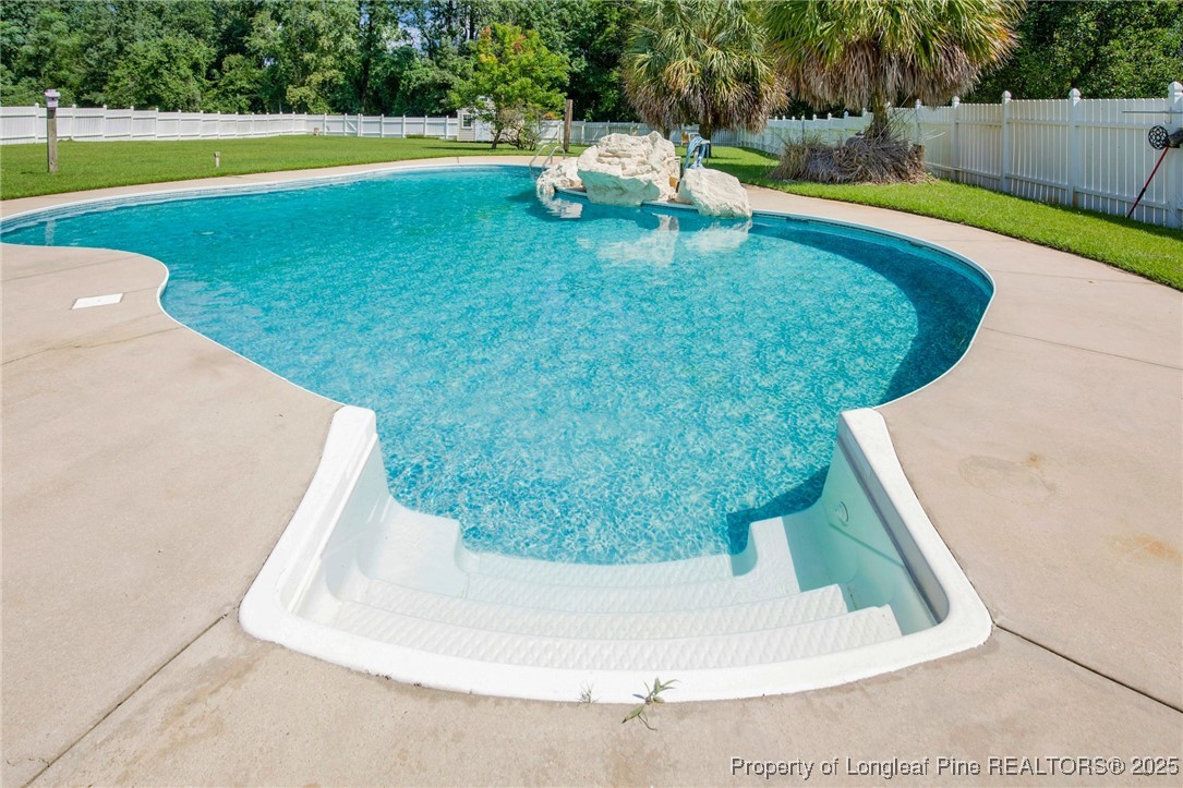 995 Adcox Road Raeford, NC 28376 - Photo 45 of 50 a view of a swimming pool with an outdoor space