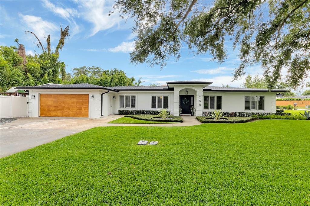 a front view of a house with a garden