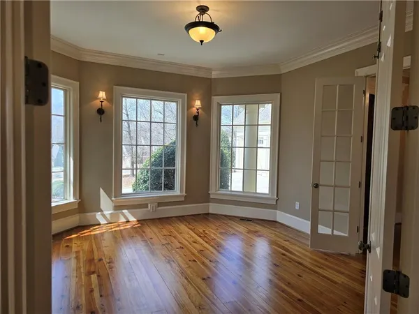 a view of a kitchen with wooden floor and electronic appliances
