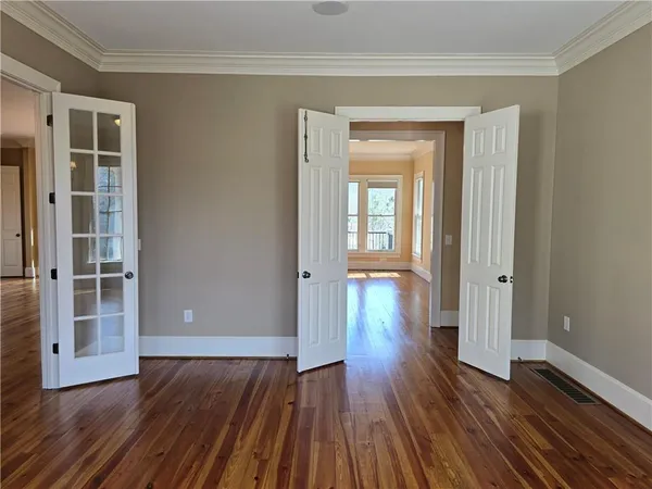 a room with a wooden floor and white walls