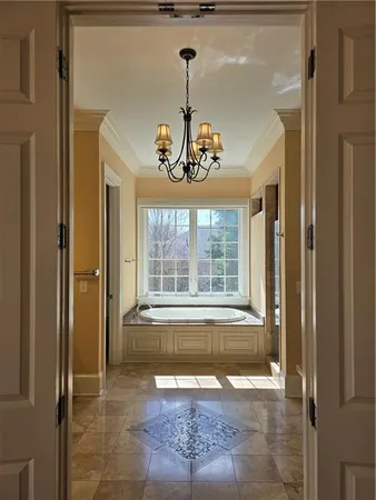 an empty room with wooden floor fireplace and windows