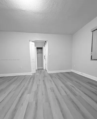 a view of an empty room and wooden floor