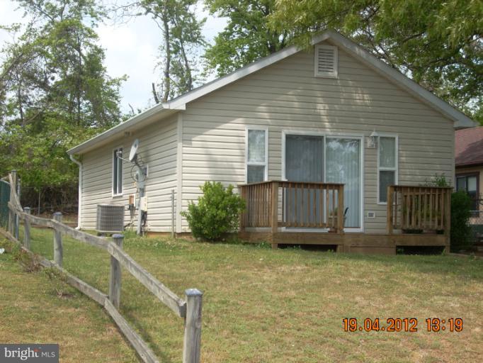 a view of a house with wooden fence