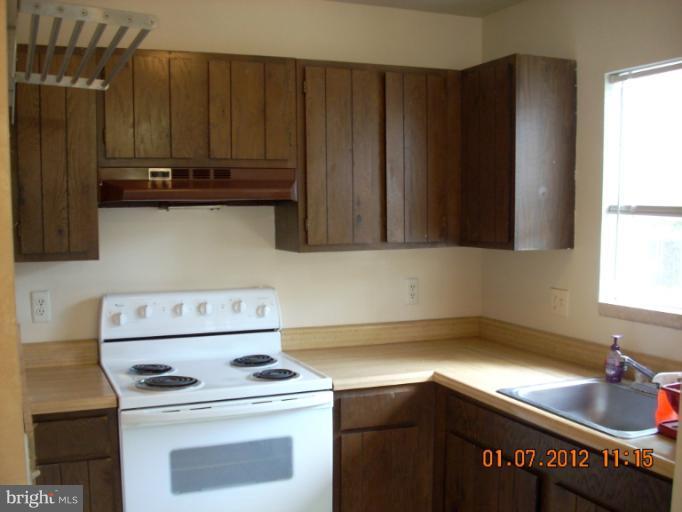 1608 Marlboro Road Edgewater, MD 21037 - Photo 24 of 24 a kitchen with a stove and a cabinet
