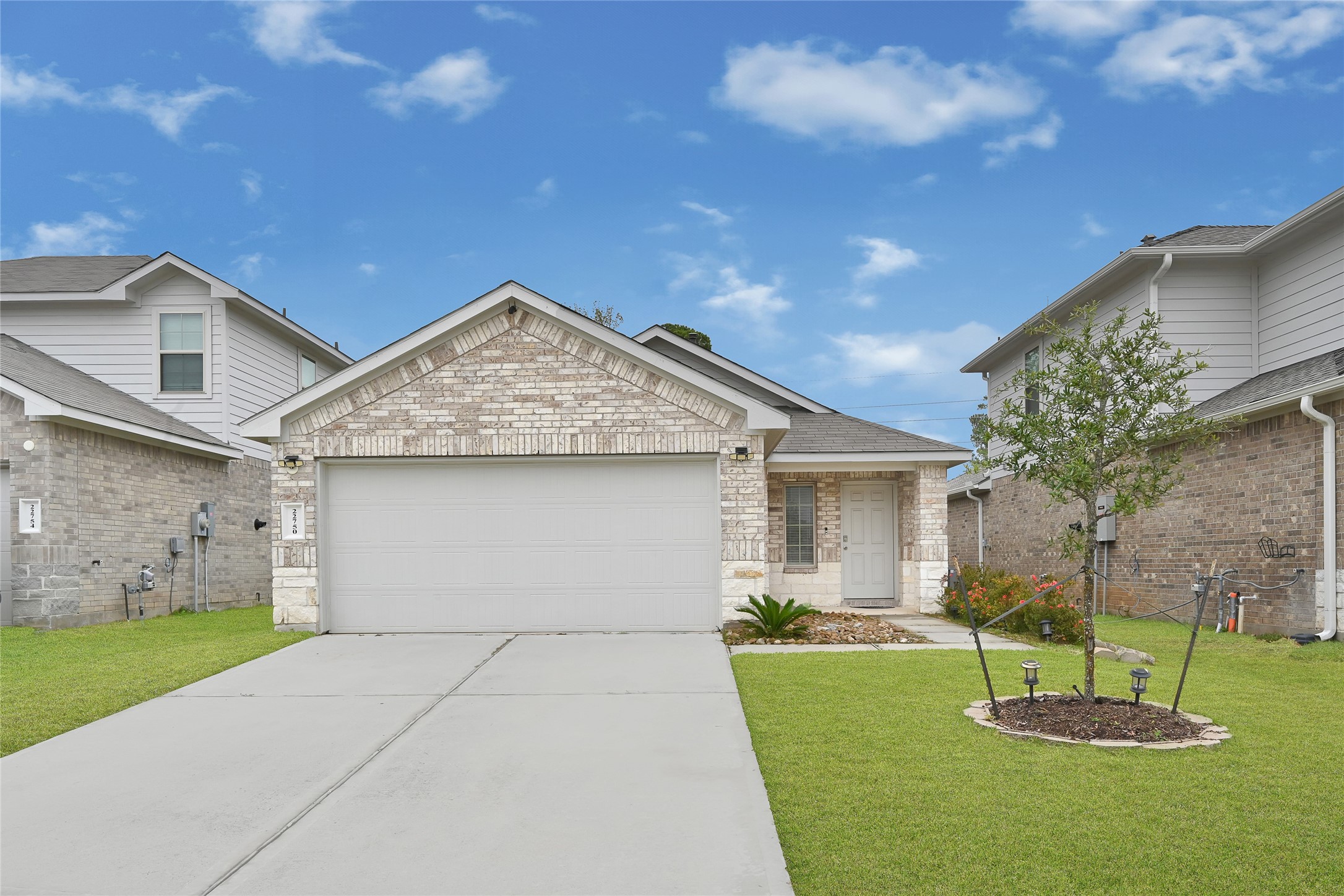 22750 Winter Maple Trail Spring, TX 77373 - Photo 1 of 18 a front view of a house with a yard and garage