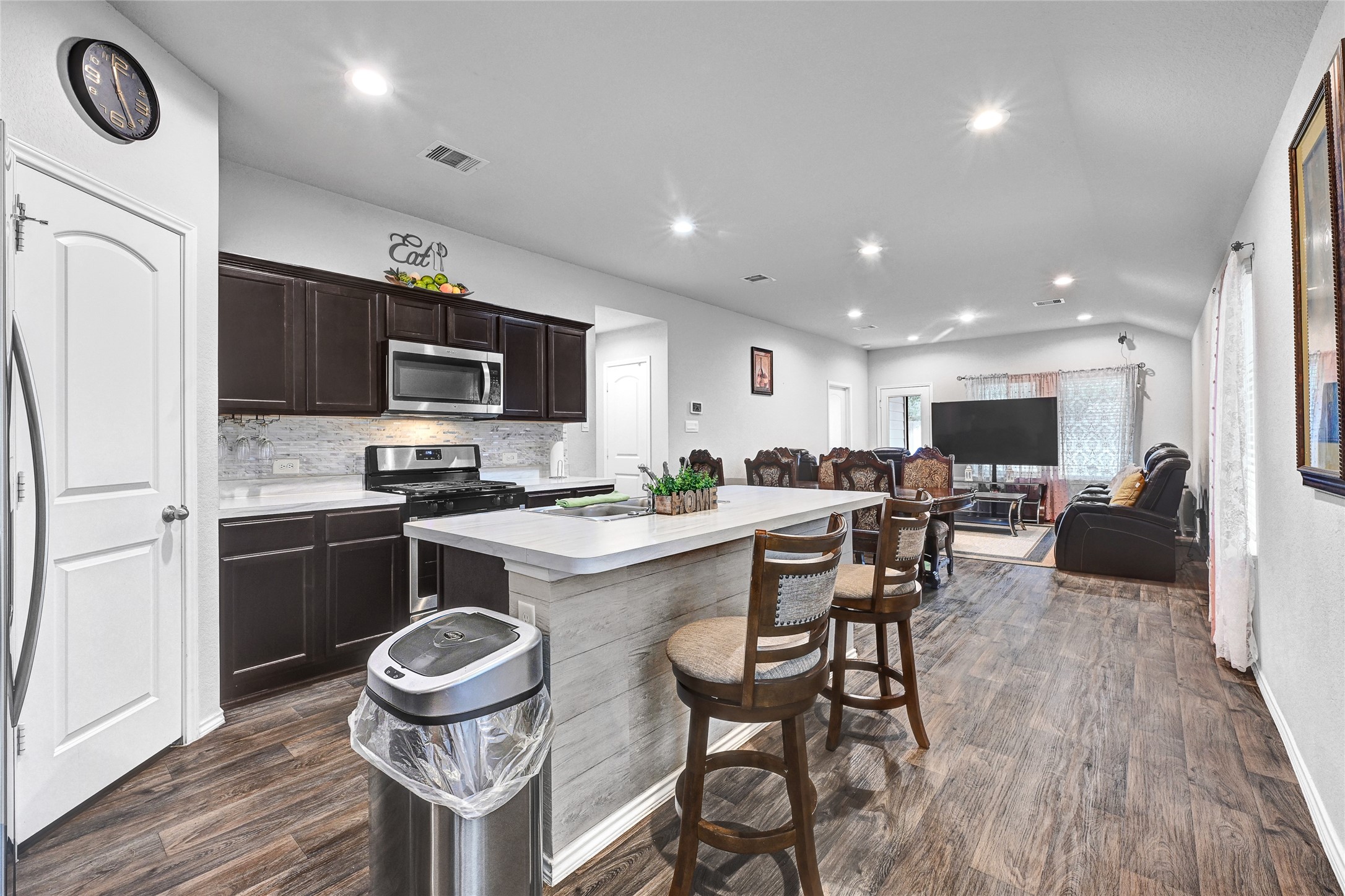 22750 Winter Maple Trail Spring, TX 77373 - Photo 5 of 18 a kitchen with sink a stove and chairs