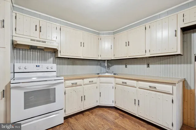 an empty room with fan and windows