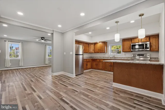 a kitchen with stainless steel appliances granite countertop a stove microwave and cabinets