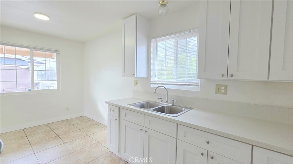 2325 Angela Street, Unit 4 Pomona, CA 91766 - Photo 14 of 21 a kitchen with a sink cabinets and window