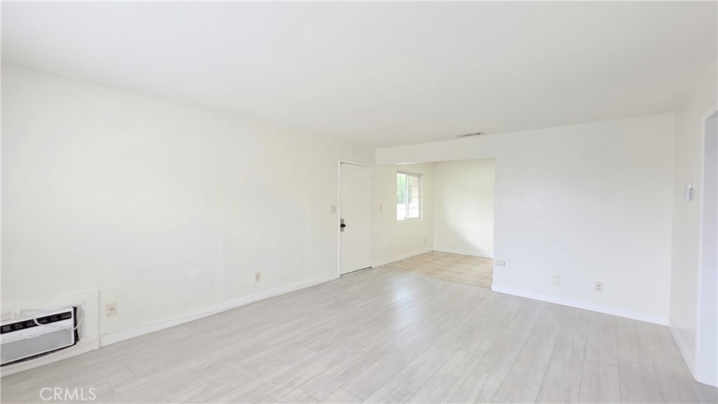 2325 Angela Street, Unit 4 Pomona, CA 91766 - Photo 2 of 21 an empty room with wooden floor and windows