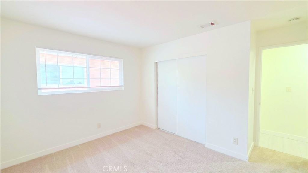 2325 Angela Street, Unit 4 Pomona, CA 91766 - Photo 8 of 21 an empty room with windows