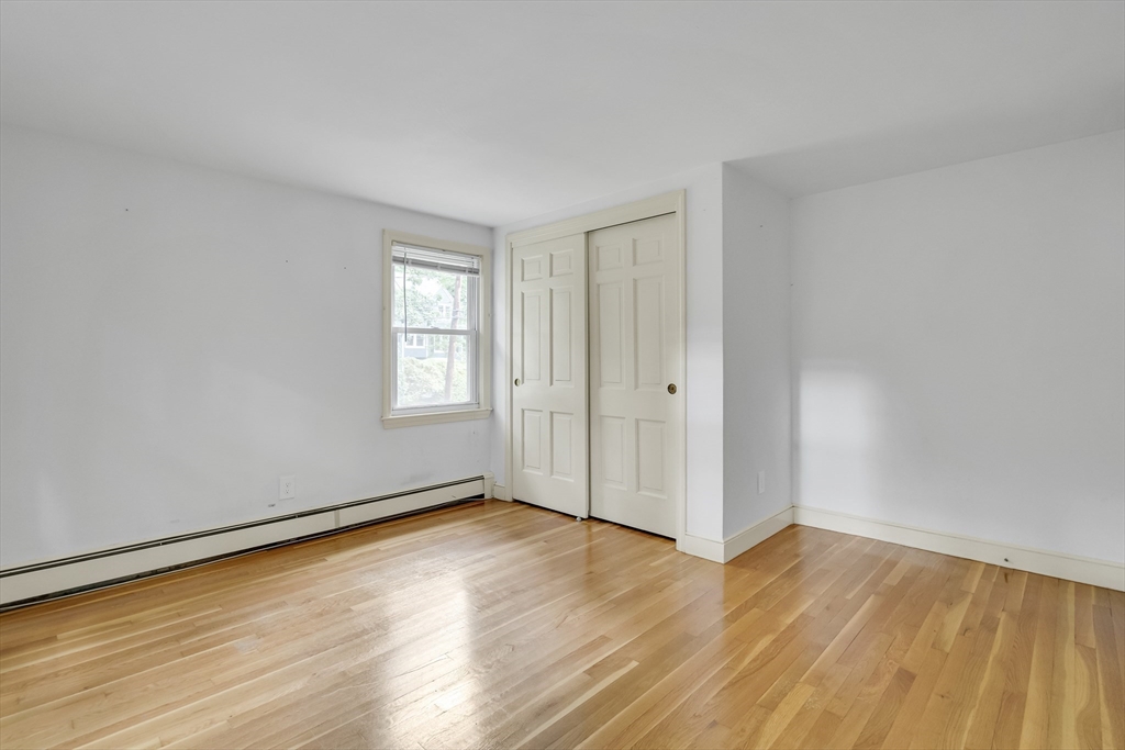 32 Dewey Road Lexington, MA 02420 - Photo 27 of 32 a view of an empty room with wooden floor and a window