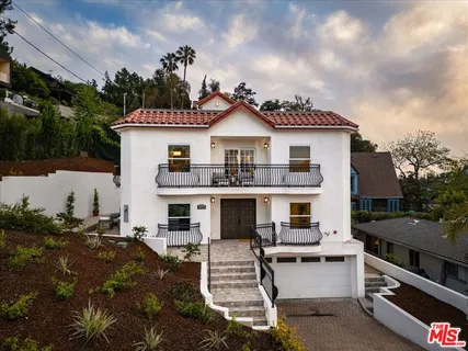an aerial view of a house with a lake view