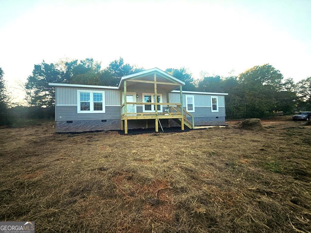 600 Tibbs Bridge Road Chatsworth, GA 30705 - Photo 1 of 1 a front view of a house with a garden