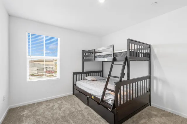 a bedroom with a bed and window