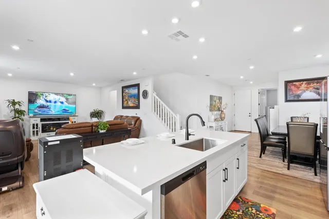 a kitchen with stainless steel appliances a sink stove and cabinets