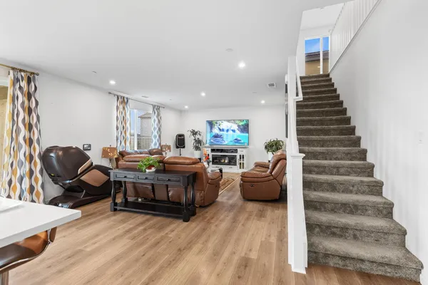 a living room with furniture and wooden floor