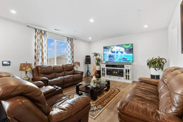 a living room with furniture a large window and a flat screen tv